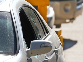 Bullet holes in the windows of an Acura sedan mark the scene of a fatal shooting in an alley in the 1800 block of 26th Avenue S.W. in South Calgary on Saturday, May 22, 2021.