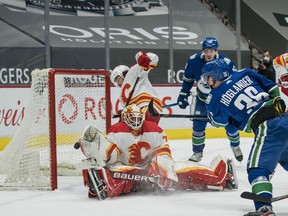 Canucks forward Nils Hoglander scores on Calgary Flames goalie Loius Dominque as defenceman Nikita Nesterov looks on  in the first period at Rogers Arena in Vancouver. Mandatory Credit: Bob Frid-USA TODAY Sports ORG XMIT: IMAGN-445772