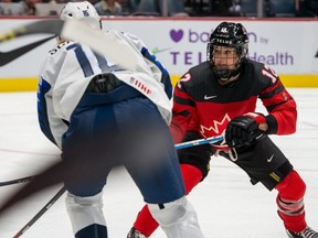 Team Canada's Meaghan Mikkelson, a proud mom of two, competes last winter in the Rivalry Series against the U.S. (Matthew Murnaghan photo, courtesy of Hockey Canada)