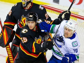 Calgary Flames defenceman Noah Hanifin battles against Tanner Pearson of the Vancouver Canucks during a game earlier this season.