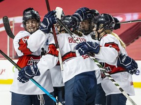 Team Scotiabank players celebrate a goal during their game against Team Bauer during the PWHPA Secret Dream Gap Tour at the Saddledome in Calgary on Friday, May 28, 2021.
