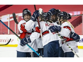 Team Scotiabank players celebrate a goal during their game against Team Bauer during the PWHPA Secret Dream Gap Tour at the Saddledome in Calgary on Friday, May 28, 2021.