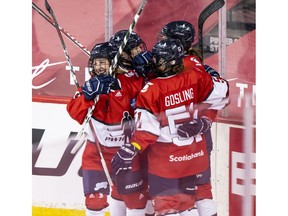 Team Scotiabank players celebrate during their game against Team Sonnet at the PWHPA Secret Dream Gap Tour tournament at the Saddledome in Calgary on Saturday, May 29, 2021.