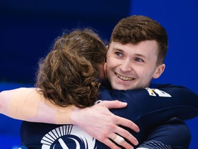 Scotland's Jennifer Dodds and Bruce Mouat share a hug Saturday as they defeated Canada's Kerri Einarson and Brad Gushue in the semifinals at the 2021 World Mixed Doubles Curling Championship in Aberdeen Scotland.