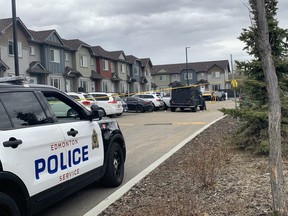 Police are seen in the area of 125 Street and 147 Avenue where a man was shot by Edmonton police early Saturday morning.
