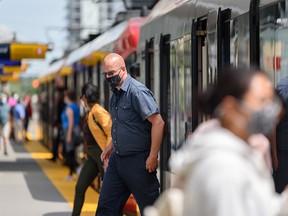 Calgary transit users wear masks while using the CTrain at City Hall station on Wednesday, June 23, 2021.