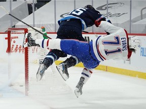 The Jets’ Mark Scheifele flattens Jake Evans after he scored an empty-net goal in last minute of the Canadiens’ 5-3 win in Game 1 of North Division final Wednesday night in Winnipeg.