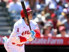 Shohei Ohtani of the Los Angeles Angels watches as the ball clears the wall on a two-run home run in the fifth inning of the game against the Detroit Tigers at Angel Stadium in Anaheim, Calif., on Sunday, June 20, 2021.