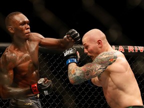 GLENDALE, ARIZONA - JUNE 12: Israel Adesanya of Nigeria throws a left on Marvin Vettori of Italy during their UFC 263 middleweight championship match at Gila River Arena on June 12, 2021 in Glendale, Arizona.
