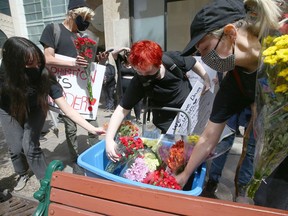 Supporters gather at 8 Ave and 4 St SW in downtown Calgary on Friday, June 11, 2021 in a show of solidarity with drug users and Calgary's supervised consumption site.