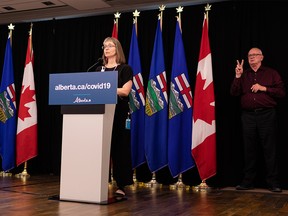 Dr. Deena Hinshaw (left), Alberta chief medical officer of health, gives her final regularly scheduled COVID-19 update next to ASL interpreter Randy Dziwenka during a press conference at the Federal Building in Edmonton, on Tuesday, June 29, 2021.