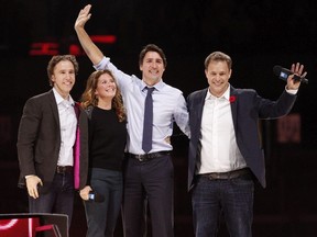 Prime Minister Justin Trudeau and his wife Sophie Gregoire-Trudeau are flanked by We Day co-founders Craig Kielburger, left, and Marc Kielburger, right.