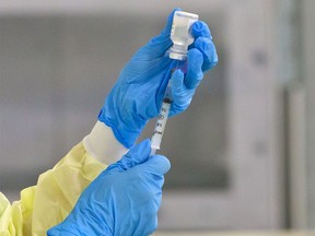 Staff prepare vaccine at the pop-up COVID-19 vaccination clinic at the Village Square Leisure Centre in northeast Calgary on June 6, 2021.