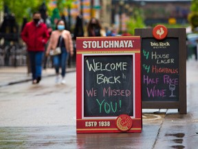 A sign outside Bank & Baron welcomed back customers to indoor dining on Thursday, June 10, 2021. Stage 2 of Alberta's reopening plan now allows indoor restaurant dining for groups of up to six.