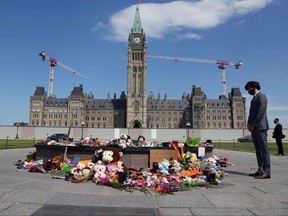 Prime Minister Justin Trudeau visits the makeshift memorial erected in honor of the 215 indigenous children remains found at a boarding school in British Columbia, on Parliament Hill June 1, 2021 in Ottawa.
