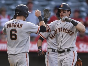 San Francisco Giants left fielder Mike Tauchman celebrates with centre fielder Steven Duggar after a three-run home run during the 13th inning against the Los Angeles Angels at Angel Stadium in Anaheim, Calif., on Wednesday, June 23, 2021.