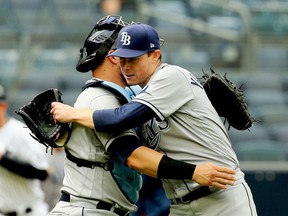 Jun 3, 2021; Bronx, New York, USA; Tampa Bay Rays starting pitcher Ryan Yarbrough (48) is congratulated by catcher Mike Zunino (10) after pitching a complete game against the New York Yankees at Yankee Stadium. Mandatory Credit: Andy Marlin-USA TODAY Sports ORG XMIT: IMAGN-432491