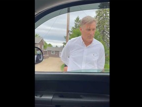 This screengrab taken from a video posted on Maxime Bernier's Twitter account on Friday shows the People's Party leader being arrested by an RCMP officer for violating public health orders.