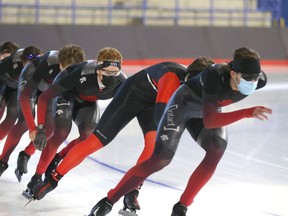 Speed skaters train at the Olympic Oval in Calgary on Friday.