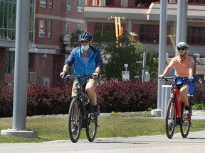 Bicyclist's are seen enjoying a warm afternoon near the Bow River along River Walk near Riverfront Ave. SE. Thursday, June 17, 2021. Brendan Miller/Postmedia