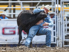Curtis Cassidty, of Donalda, Alta., clocks the fastest time in steer wrestling at the Calgary Stampede on Sunday, July 11, 2021.
