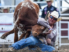 Jacob Edler of State Center, IA wins the Steer Wrestling Performance on the eighth day of the Calgary Stampede on Friday, July 16, 2021. Azin Ghaffari/Postmedia