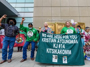 Melody Ayoungman, whose son Kristian Ayoungman was shot to death by Brandon Giffen, is surrounded by her friends, family and community after hearing the verdict outside the Calgary Courts Centre on Monday, July 26, 2021.