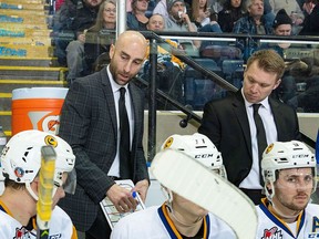 KELOWNA, BC - DECEMBER 01: Saskatoon Blades' head coach Mitch Love and assistant coach Ryan Keller stand on the bench and discusses a play against the Kelowna Rockets at Prospera Place on December 1, 2018 in Kelowna, Canada.