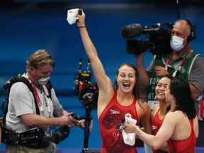 Members of Team Canada react after winning the silver medal in the Women's 4 x 100m Freestyle Relay Final.