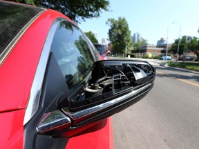 A broken side view mirror is shown on a car parked on 2nd Street S.W. near Downtown Calgary on Tuesday, July 13, 2021. A number of vehicles were damaged overnight.