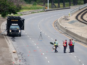 Police investigate the scene of a pedestrian hit-and-run in the eastbound lanes of Memorial Drive between Edmonton Trail and Memorial Drive on Sunday, July 4, 2021. One person was in life-threatening condition after the early morning collision.