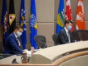 Calgary City Councillors Jeff Davison and Jeromy Farkas were photographed during the council vote to rescind the mandatory masking bylaw in the city. Mandatory masking for transit and inside city owned and operated facilities will remain for the time being. Council voted on Monday, July 5, 2021.