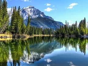 Cascade Mountain reflecting in the Bow River in Banff National Park, Alberta, Canada.