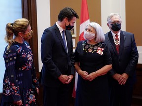 Governor General Mary Simon and Prime Minister Justin Trudeau speak as Sophie Gregoire Trudeau and Whit Fraser look take part in the Signing of the Oath Registry after Simon took the oath to become the 30th Governor General of Canada in Ottawa, July 26, 2021.