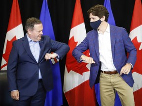 Prime Minister Justin Trudeau bumps elbows with Alberta Premier Jason Kenney after a meeting in Calgary on July 7, 2021.