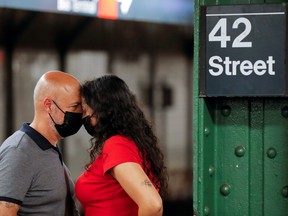 People waiting for a subway wear masks as cases of the infectious coronavirus Delta variant continue to rise in New York City, July 26, 2021.