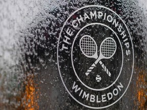 In this file photo a water feature with the Wimbledon logo stands by the members area at the All England Tennis Club in Wimbledon, southwest London, on July 1, 2018, on the eve of the 2018 Wimbledon Championships tennis tournament.