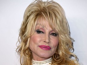In this file photo taken on February 08, 2019 US singer-songwriter and 2019 MusiCares Person Of The Year Dolly Parton arrives for the 2019 MusiCares Person Of The Year gala at the Los Angeles Convention Center in Los Angeles.