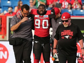 Calgary Stampeders defensive lineman Folarin Orimolade is helped off the field after being injured during pre-season CFL action against the Saskatchwan Roughriders at McMahon Stadium in Calgary on May 31, 2019.