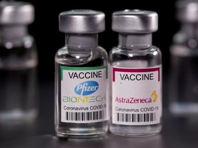 Vials with Pfizer-BioNTech and AstraZeneca coronavirus disease (COVID-19) vaccine labels are seen in this illustration picture taken March 19, 2021.