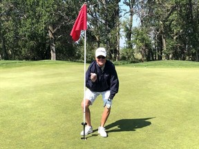 High River resident Jim Hargreaves retrieves his latest keepsake after carding a hole-in-one on No. 6 on the Heritage loop at Highwood. Hargreaves, 71, now has a dozen career aces.