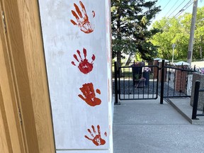 Graffiti is shown on the front of Assumption of the Blessed Virgin Mary Ukranian Catholic Church in Calgary on July 1, 2021. A number of churches were vandalized overnight in Calgary.