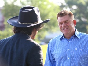 Former Wildrose leader Brian Jean speaks with a visitor during a quiet Stampede-themed pancake breakfast at Rutland Park Community Centre in Calgary on Tuesday, July 13, 2021.