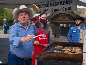 Premier Jason Kenney keeps a sharp eye on the prize as he shows off his pancake flipping skills at the annual Premier's Stampede Breakfast in downtown Calgary on Monday, July 12, 2021.