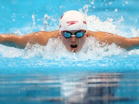 Maggie MacNeil of Canada powers her way to a gold medal in the 100m Women's Butterfly at the Tokyo 2020 Olympics on July 24, 2021.