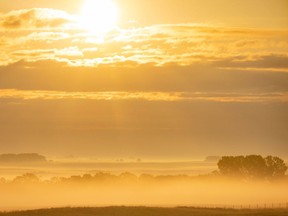 Sunrise over the misty landscape south of Carseland, Ab., on Wednesday, July 7, 2021. Mike Drew/Postmedia