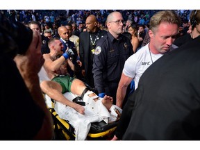 Conor McGregor is carried off a stretcher following an injury suffered against Dustin Poirier during UFC 264 at T-Mobile Arena in Vegas.