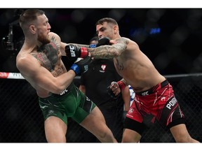 Dustin Poirier moves in for a hit as Conor McGregor defends during UFC 264 at T-Mobile Arena in Las Vegas. Gary A. Vasquez-USA TODAY Sports