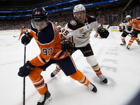 The Edmonton Oilers’ Ryan Nugent-Hopkins battles the Anaheim Ducks’ Andy Welinski at Rogers Place in Edmonton on March 30, 2019.
