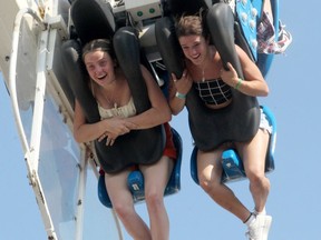 Thrill seekers are seen riding Mach 3 on the midway on the Stampede Grounds. Friday, July 9, 2021. Brendan Miller/Postmedia
